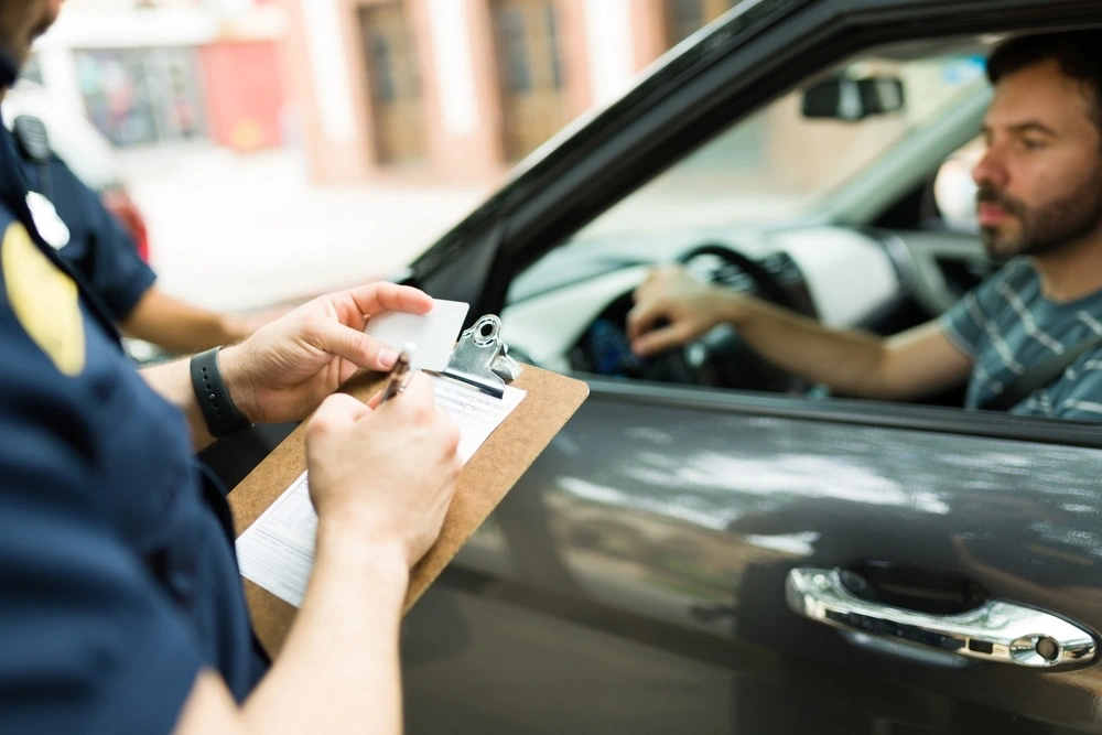 A police officer stops a driver, an action that warrants the suspension of the driver's license