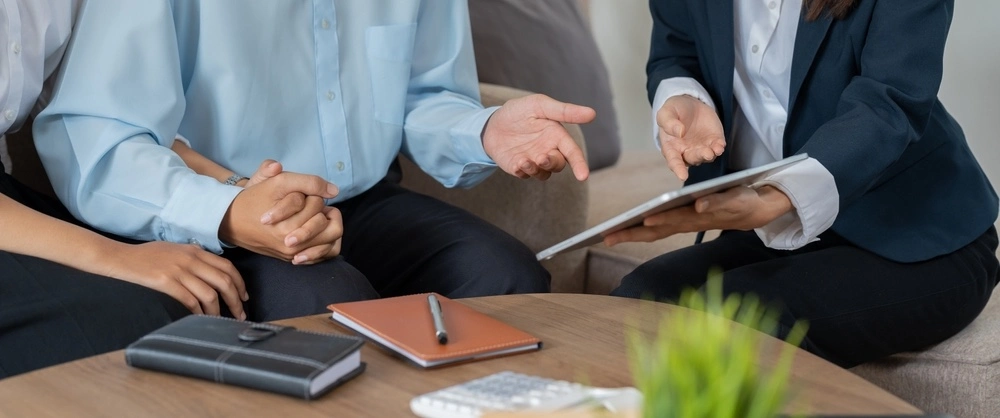 A person consults with a supportive family member, symbolizing the crucial role of prevention and rehabilitation efforts