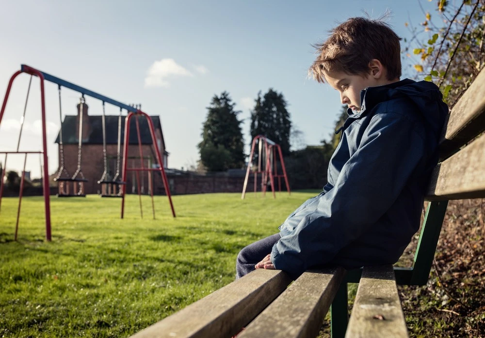 A snapshot of a sad child, depicting the concept of child abuse laws in California.
