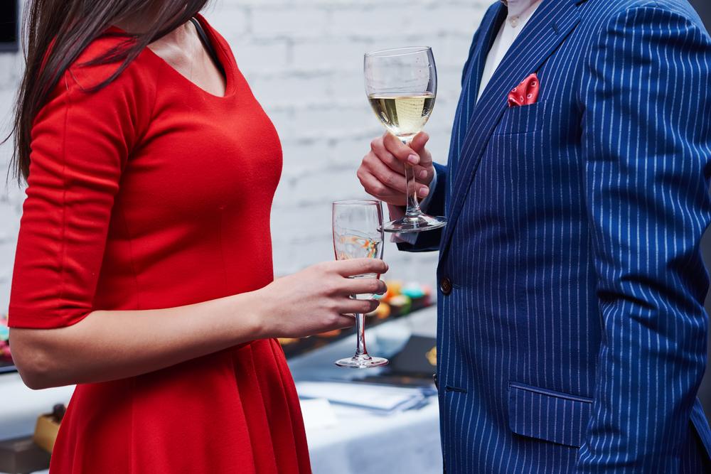 A man and woman hold glasses of wine at a formal party. In California, an escort offers paid companionship, which is legal. Issues arise when police look at a message or post and assume it involved sexual activity.